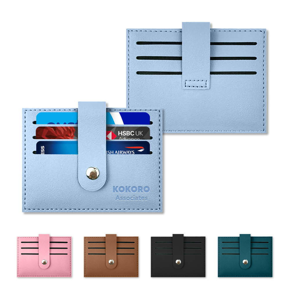 Snap-close leather card holders in light blue, pink, tan, black and teal with Kokoro Associates branding